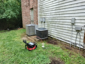 Sewer scope performing a video pipe inspection on a clean-out. 